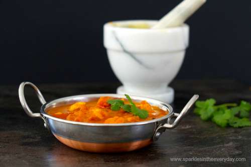 Mortar and Pestle with delicious Tomato and Chicken Curry