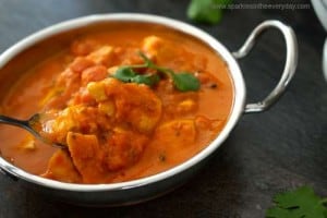 a spoonful of tomato and chicken curry
