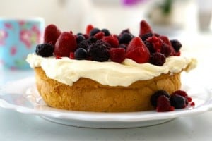 Gluten Free Cake topped with fresh cream and mixed berries