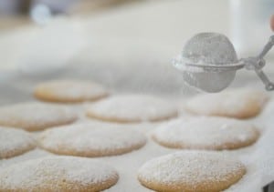 Dusting Powdered Sugar over Gluten Free Vanilla and Almond Cookies